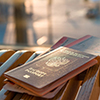 Passports with boarding passes tucked in - window with out-of-focus planes in background