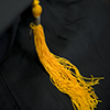 mortarboard cap with yellow tassel close up