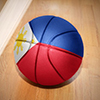basketball ball with the national flag of philippines lying on the floor near the white line