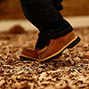 Boy Boots In Playground Woodchips 