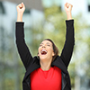 Single excited executive raising arms after success on the street
