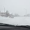snowy road seen through windshield