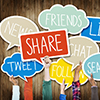 Hands Holding Speech Bubbles with Social Media Words