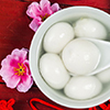 Chinese style glutinous rice balls served in a bowl with Chinese New Year decoration