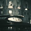 Taxi sign on street, black and white