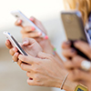 Portrait of three girls chatting with their smartphones at the campus