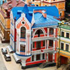 Multicolored houses among the green trees and blue sky. Panoramic view from the hill. Placed in Kiev