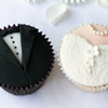 cupcakes decorated with fondant to look like groom's tuxedo and bride's dress
