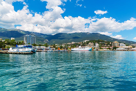 Scenic summer panorama of Black Sea pier and port harbor in Yalta, Crimea, Ukraine