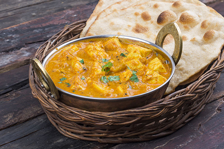 steel dish with veggie korma - served in basket tray with naan